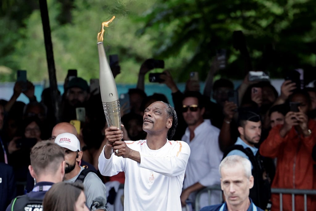 US rapper Snoop Dogg holds the torch as part of th