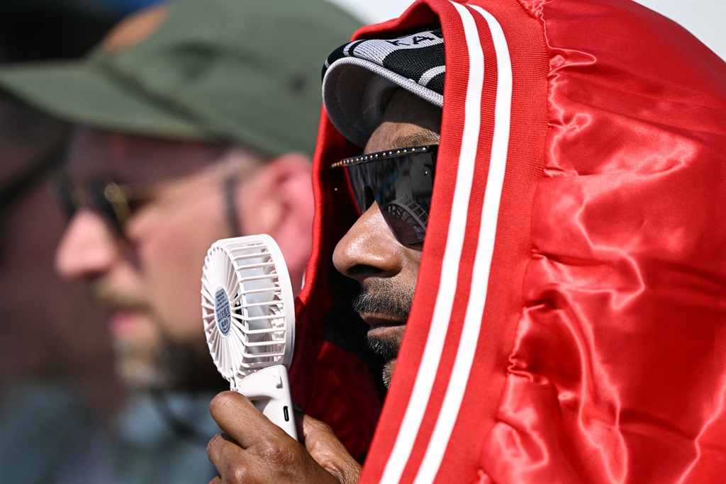 US rapper Snoop Dogg drapes a jacket around his he