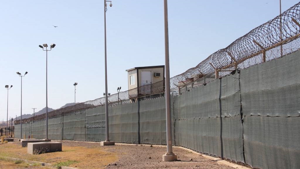 A guard tower is seen outside the fencing of Camp 