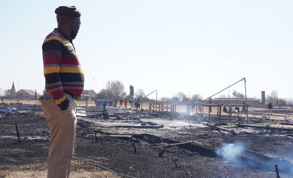 A member of the community looking at what is left after residents burnt Paseka "Pastor Mboro" Motsoeneng's Incredible Happenings Church to the ground. (Alfonso Nqunjana/News24)