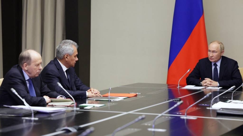 In this pool photograph distributed by Russian state-owned Sputnik agency, Russia's President Vladimir Putin (R) holds a meeting with heads of law enforcement agencies on the situation in the Kursk region, director of the Federal Security Service (FSB) of the Russian Federation, Alexander Bortnikov (L) and Secretary of the Security Council of the Russian Federation, Sergei Shoigu in Moscow. (Aleksey Babushkin/Pool/AFP)