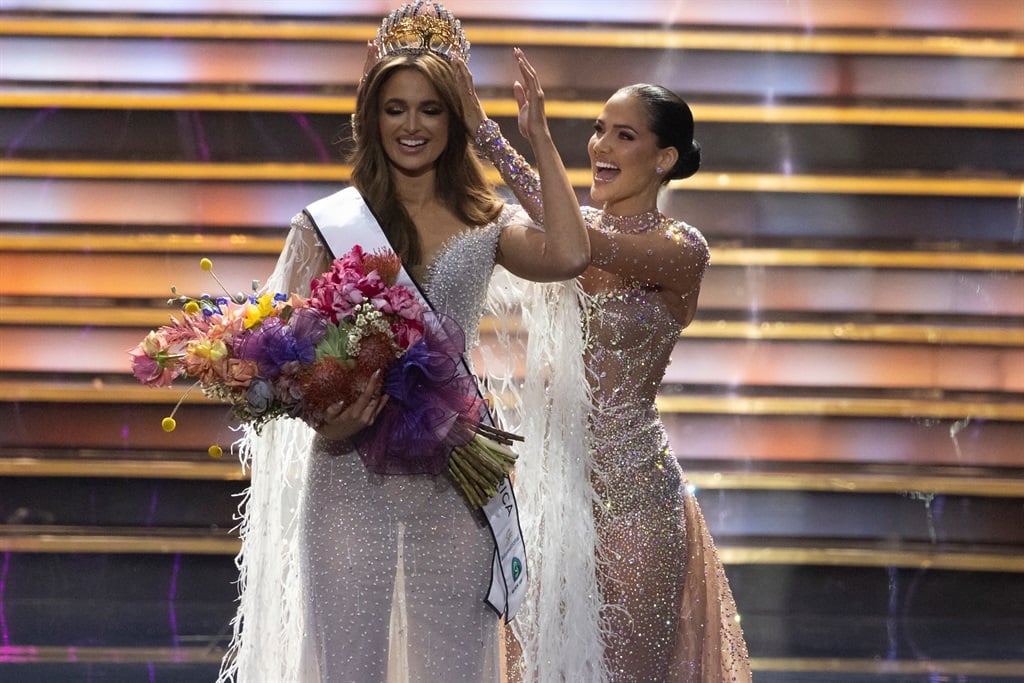 Mia Le Roux (L) is crowned by 2023 Miss South Africa Natasha Joubert (R) on stage at the 2024 Miss South Africa final at SunBet Arena in Pretoria. (MARCO LONGARI / AFP)