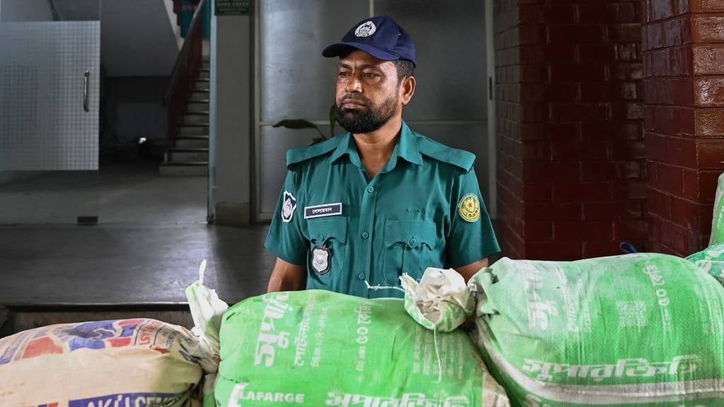 A police officer stand guard at a police station after the police force ended their strike and returned to duty in Dhaka. (Munir Uz Zaman/AFP)