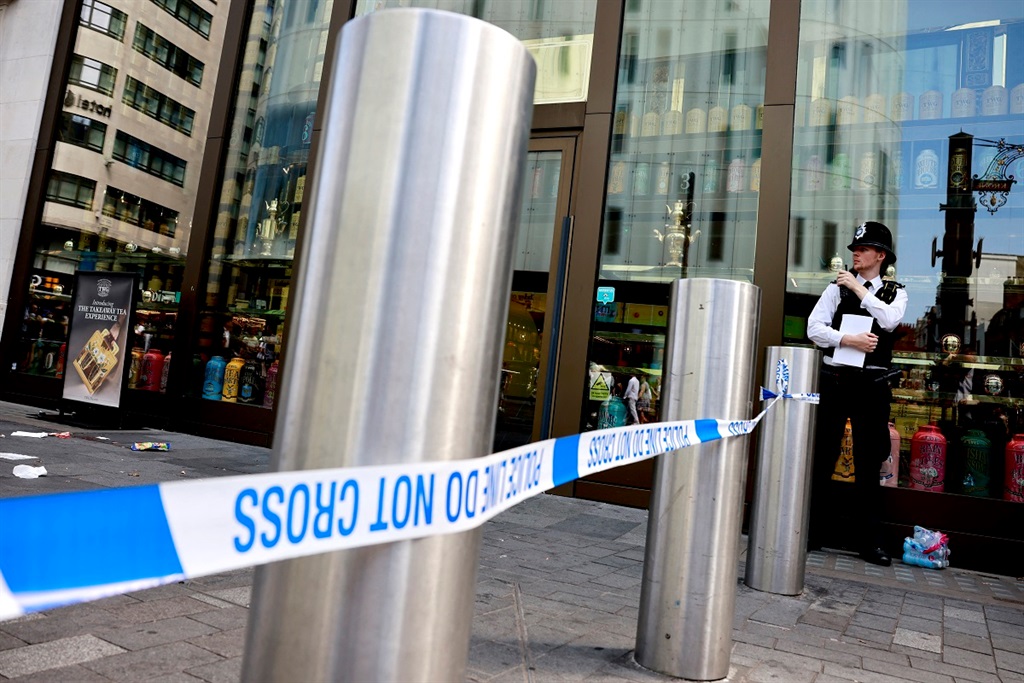 A photograph taken on 12 August 2024 shows a police officer standing by a cordoned off area in Leicester square, London. (BENJAMIN CREMEL/AFP)