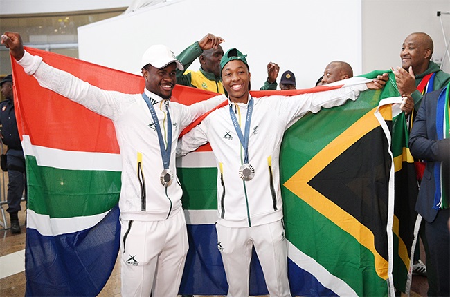 Bradley Nkoana and Bayanda Walaza during the welcoming of Tatjana Smith and part of the Athletics Relay Team by Minister Gayton Mckenzie and SASCOC at O.R Tambo International Airport (Lefty Shivambu/Gallo Images)