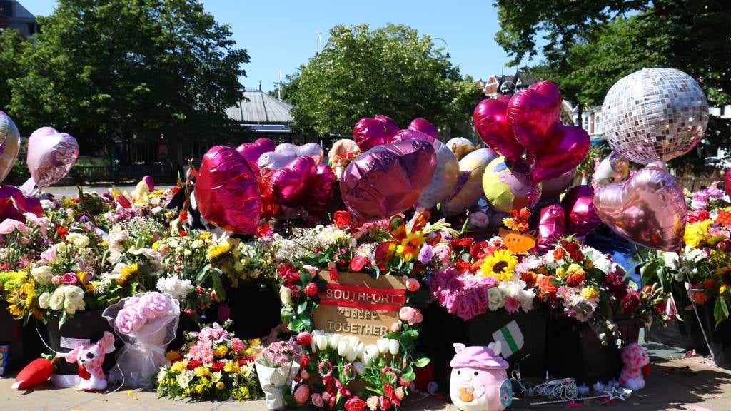 Flowers and balloons left in tribute to murdered A