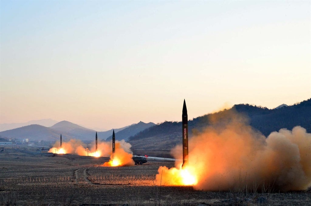 A picture released by North Korea's Korean Central News Agency (KCNA) via KNS in March 2017 shows the launch  of four ballistic missiles by during a military drill at an undisclosed location in North Korea. Such missiles could reach Japan, as missiles stationed in Japan could hit China or Russia as well as North Korea. (Photo by KCNA VIA KNS / AFP)