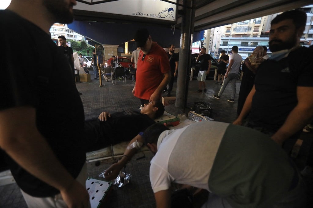 A man donates blood under a tent in Beiruts southern suburb on 17 September 2014 after explosions hit locations in several Hezbollah strongholds around Lebanon amid ongoing cross-border tensions between Israel and Hezbollah fighters. (AFP)