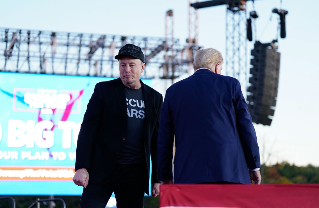 Tesla and SpaceX CEO Elon Musk speaks with former president Donald Trump during a campaign event at the Butler Farm Show, Saturday, Oct. 5, 2024, in Butler, Pa. (Photo by Jabin Botsford/The Washington Post via Getty Images)