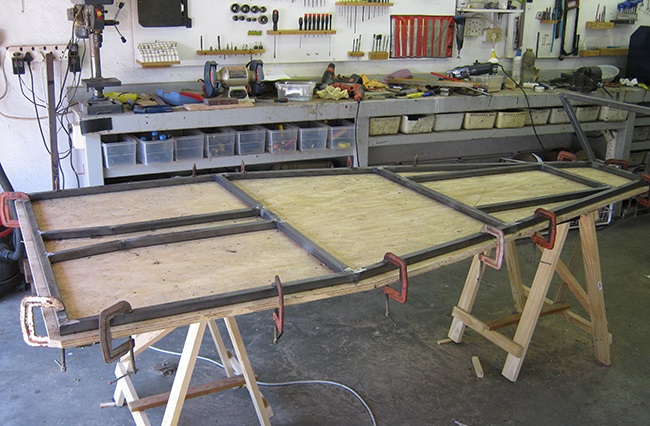 Laying first tubes on the plywood jig table