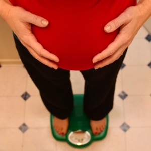 Pregnant mom on scale from Shutterstock