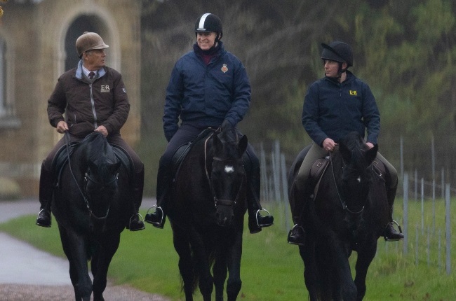 A smiling Prince Andrew (centre) spotted out ridin