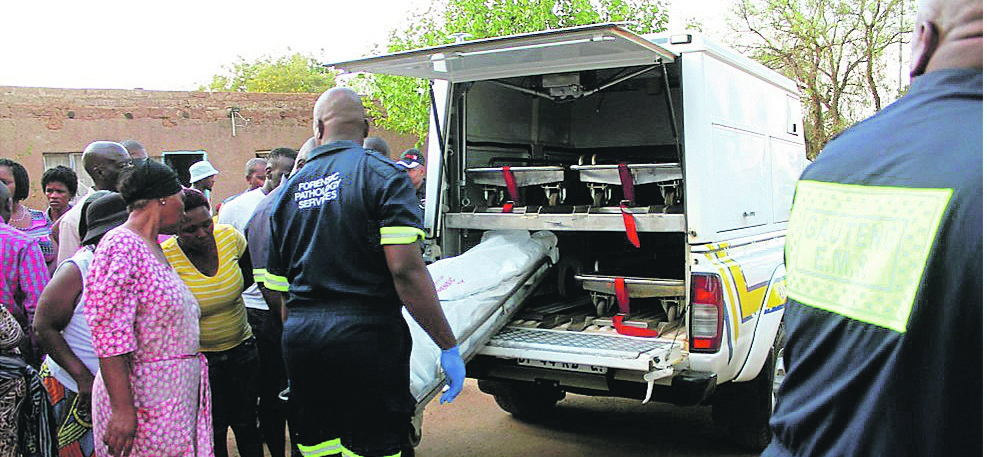 The body of Maria Sephokola is carried to the mortuary van while her family and residents look on.                     Photo by Nyiko Ka Ntsako 
