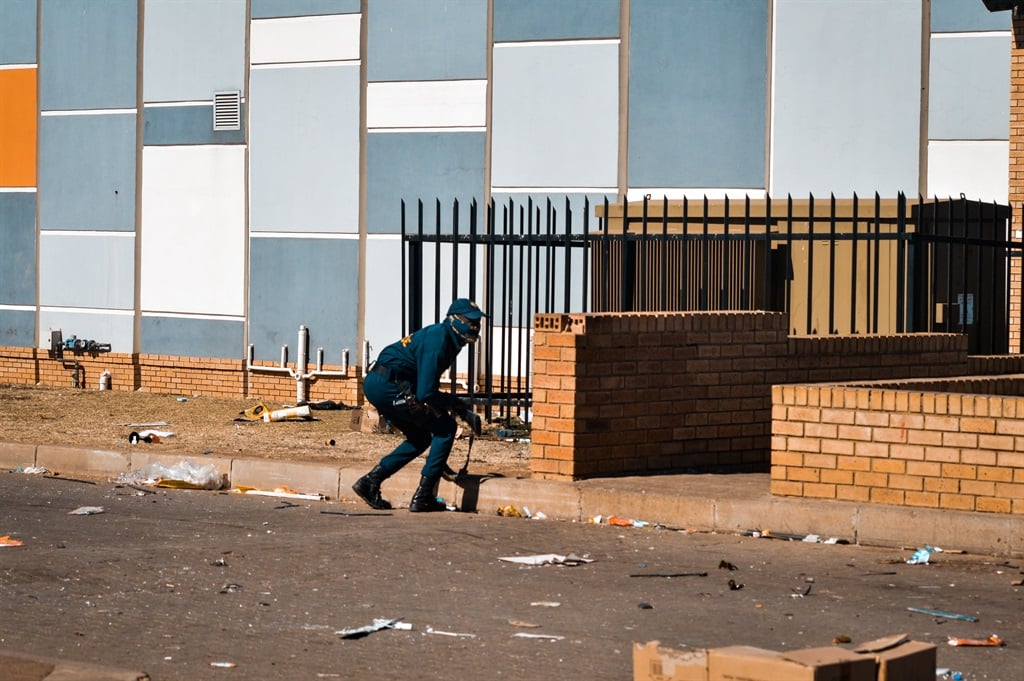 Police on the scene of looting during the July unrest in 2021.