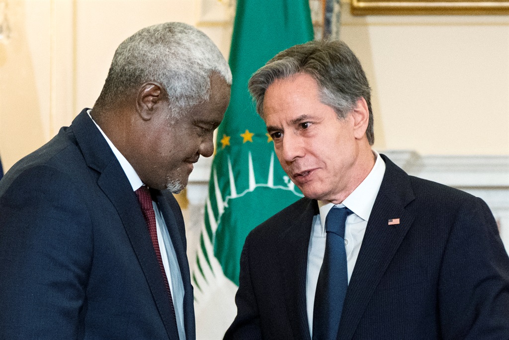 US Secretary of State Antony Blinken and African Union (AU) Commission Chairperson Moussa Faki Mahamat, exchange congratulations after signing a Memorandum of Cooperation to expand a public health partnership between the US and AU, at the State Department, March 11, 2022, in Washington, DC.
