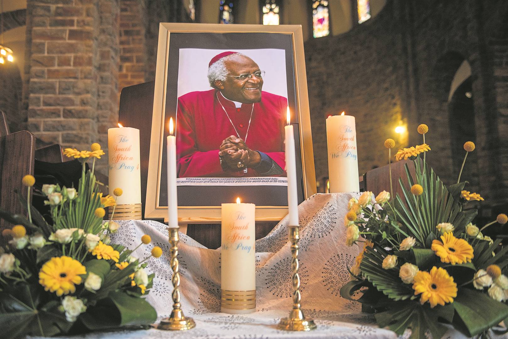 Lit candles and a photo of The Arch at his memorial service in Cape Town on Thursday.      Photo by Gallo Images/Alet Pretorius