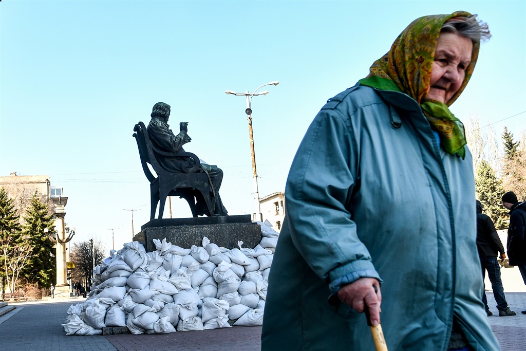 An elderly woman walks past the monument to Russian composer Mikhail Glinka surrounded by sandbags outside the Mikhail Glinka Concert Hall that is home of the Zaporizhzhia Regional Philharmonic as local volunteers, historians and museum employees attempt to protect the statue from damage in case of Russian attacks, Zaporizhzhia, southeastern Ukraine.  (Photo by Dmytro Smolyenko/Ukrinform/NurPhoto via Getty Images)