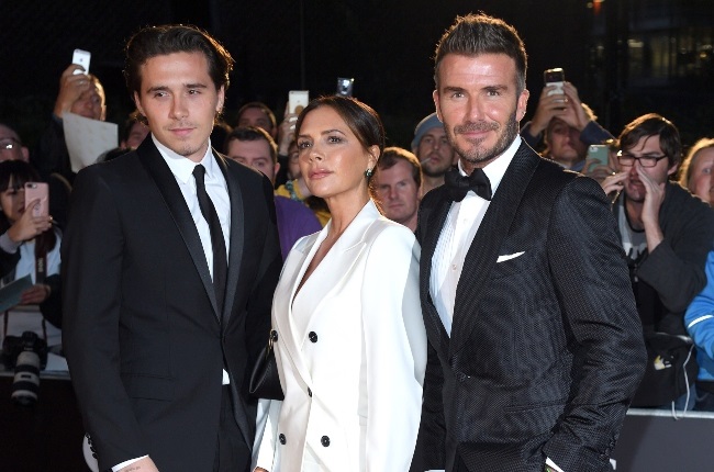Brooklyn Beckham with his parents, Victoria and David Beckham, at the GQ Men of the Year Awards in 2019. The couple decided to invite only the Cambridges, and not the Sussexes, to their eldest son's recent wedding. (PHOTO: Gallo Images/Getty Images)