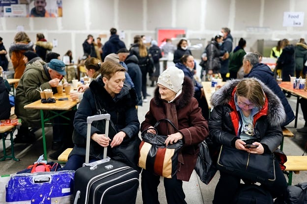 Ukrainian refugees rest upon their arrival at the 