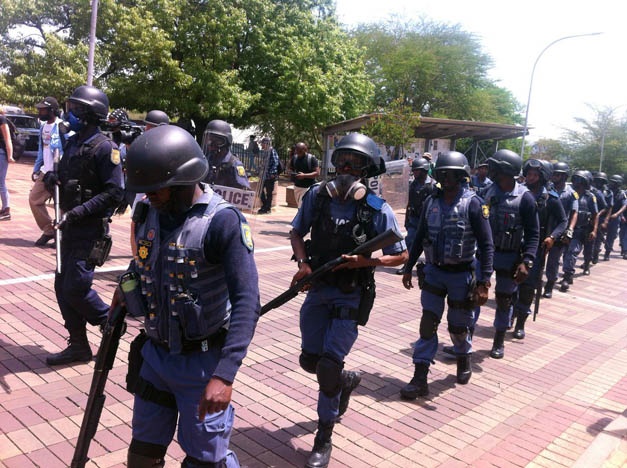 Police in full gear marching in file at Wits University. (Lizeka Tandwa/News24)