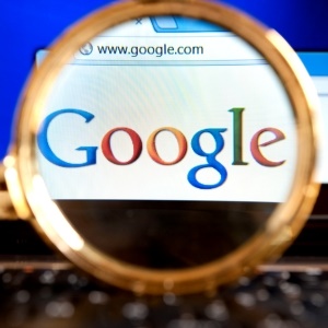 Izmir, Turkey - June 11, 2012: Close up to Google website through a magnifying glass on the laptop. Google is the most popular search engine in the world.