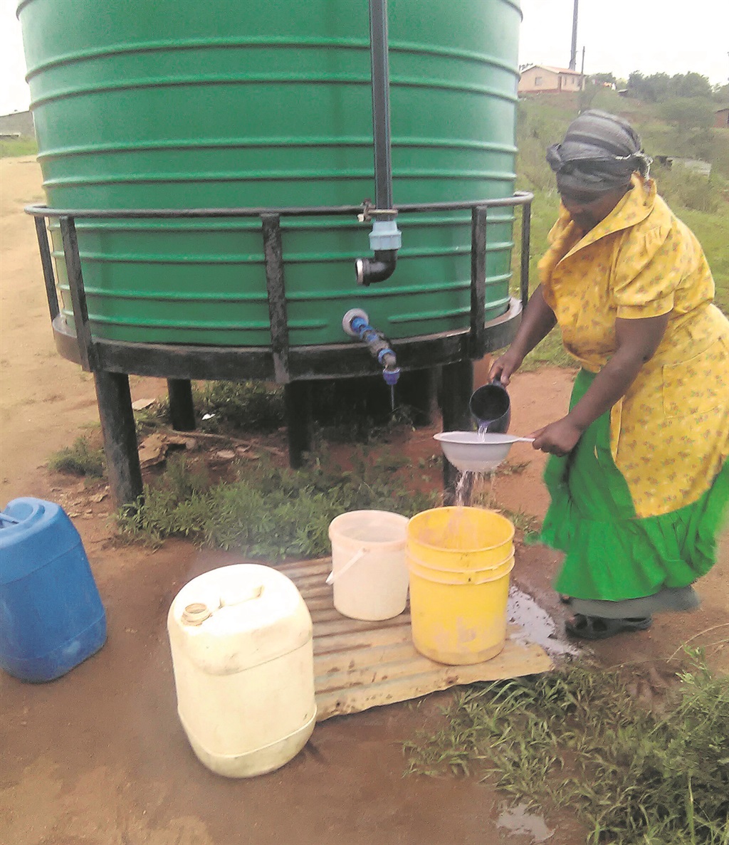woman sifting water before using it.  Photo by Noxolo Ndlovu 