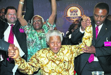 The late former president, Nelson Mandela, being helped by Bid chairman Irvin Khoza as Danny Jordaan and Archbishop Desmond Tutu celebrate after South Africa was announced as the Fifa 2010 World Cup host in Zurich, Switzerland in 2004.                        Photo by Gallo Images