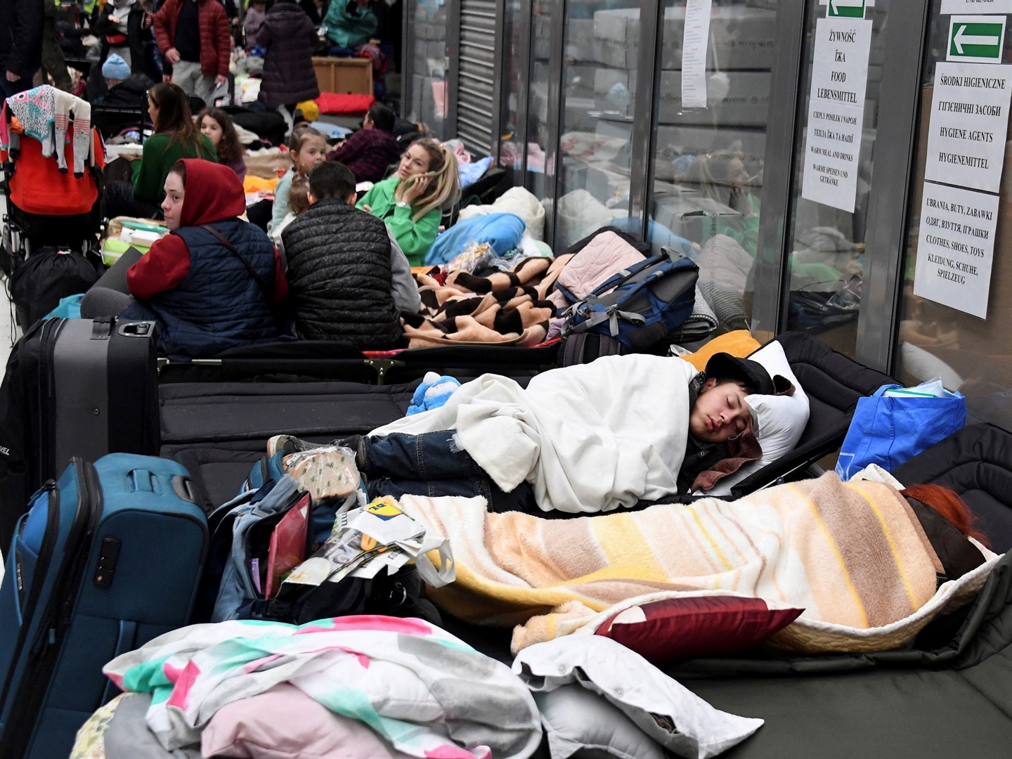 People rest at a refugee reception center at the Ukrainian-Polish border crossing in Korczowa, Poland.