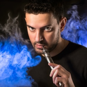 Smoking an e-cigarette – iStock