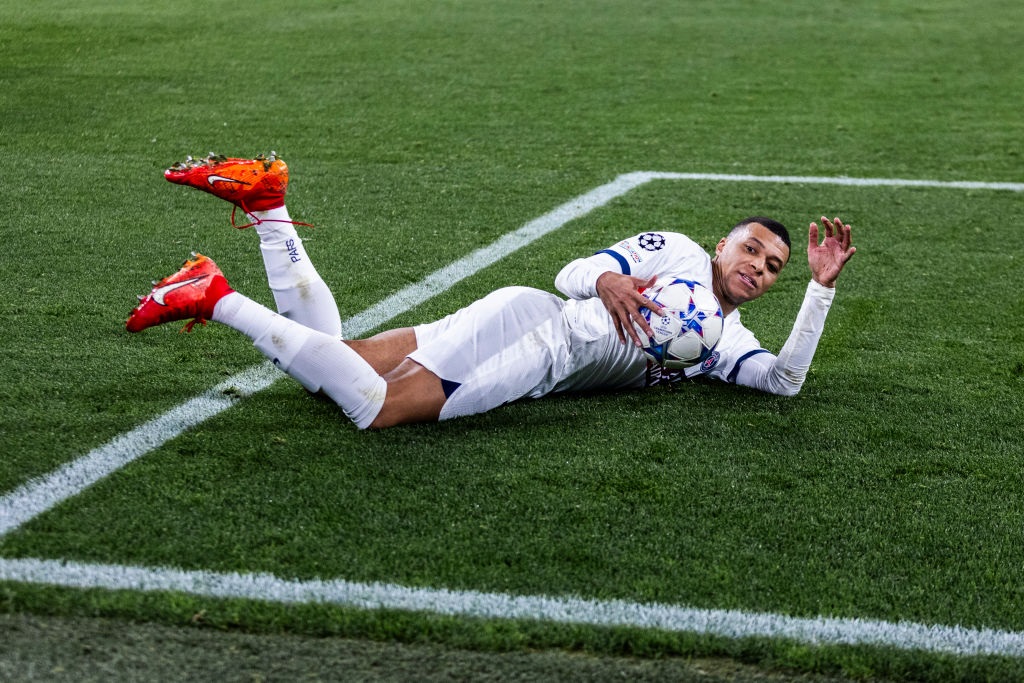 DORTMUND, GERMANY - DECEMBER 13: Kylian Mbappe of Paris lies on the ground during the UEFA Champions League match between Borussia Dortmund and Paris Saint-Germain at Signal Iduna Park on December 13, 2023 in Dortmund, Germany. (Photo by Mika Volkmann/Getty Images)