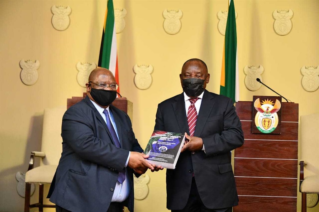 Raymond Zondo hands part 1 of the state capture report to President Cyril Ramaphosa.