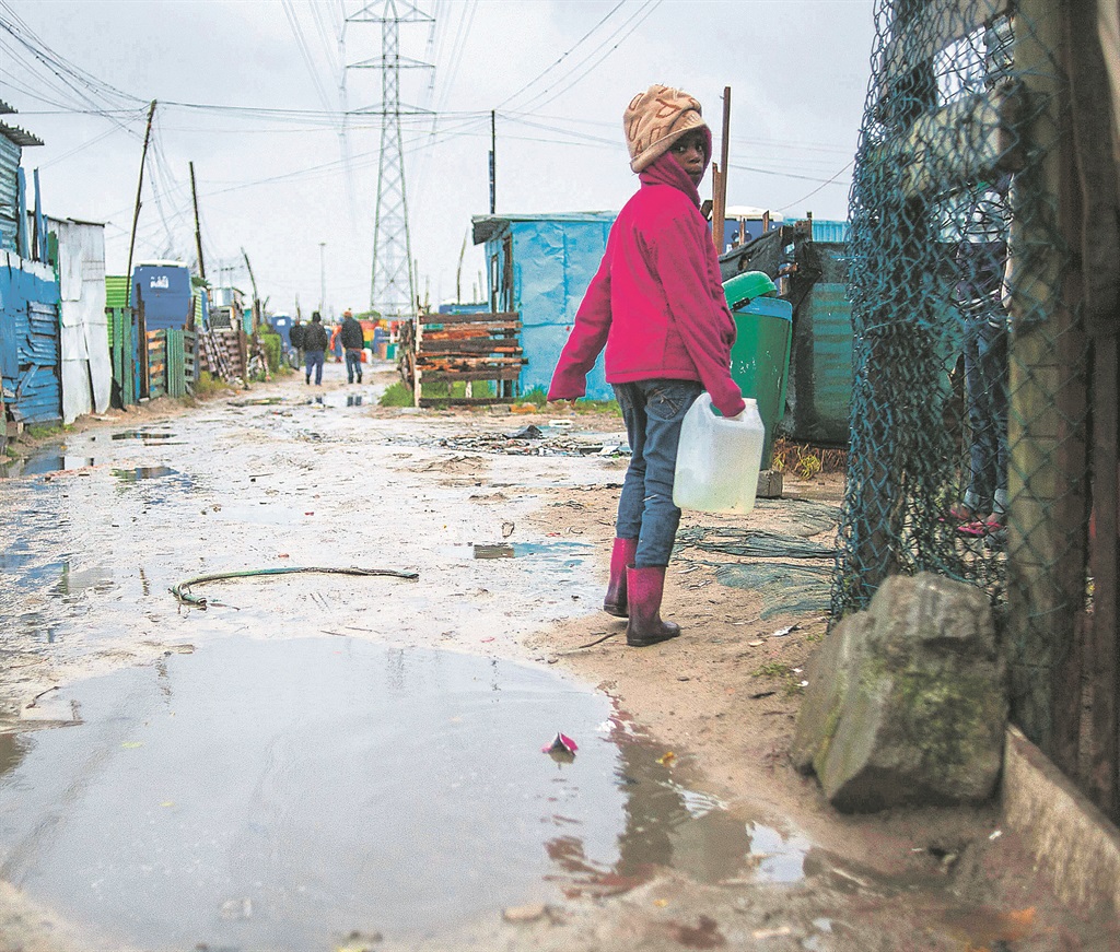 A young girl in Khayelitsha, on her way home after buying a plastic bottle of paraffin for cooking and heating. Picture: Gallo Images / The Times / David Harrison / File