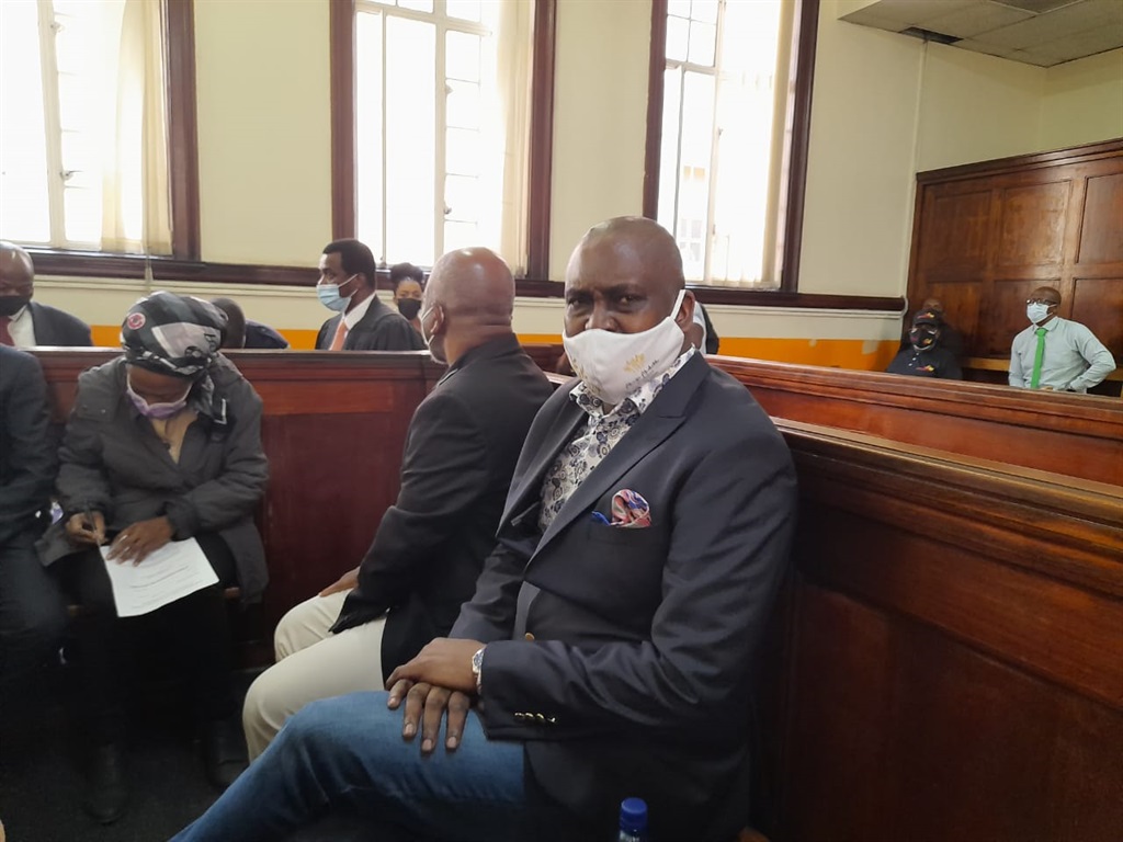 Former Gauteng health MEC Brian Hlongwa, his wife, Joelene, and their co-accused seated in the Johannesburg Magistrate's Court.