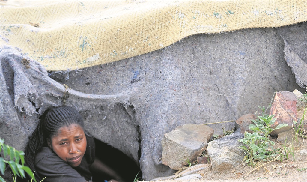 Nthabiseng Ralethe and her two children sleep in a hole she found in the veld.                                                                  Photo by Sammy Moretsi 