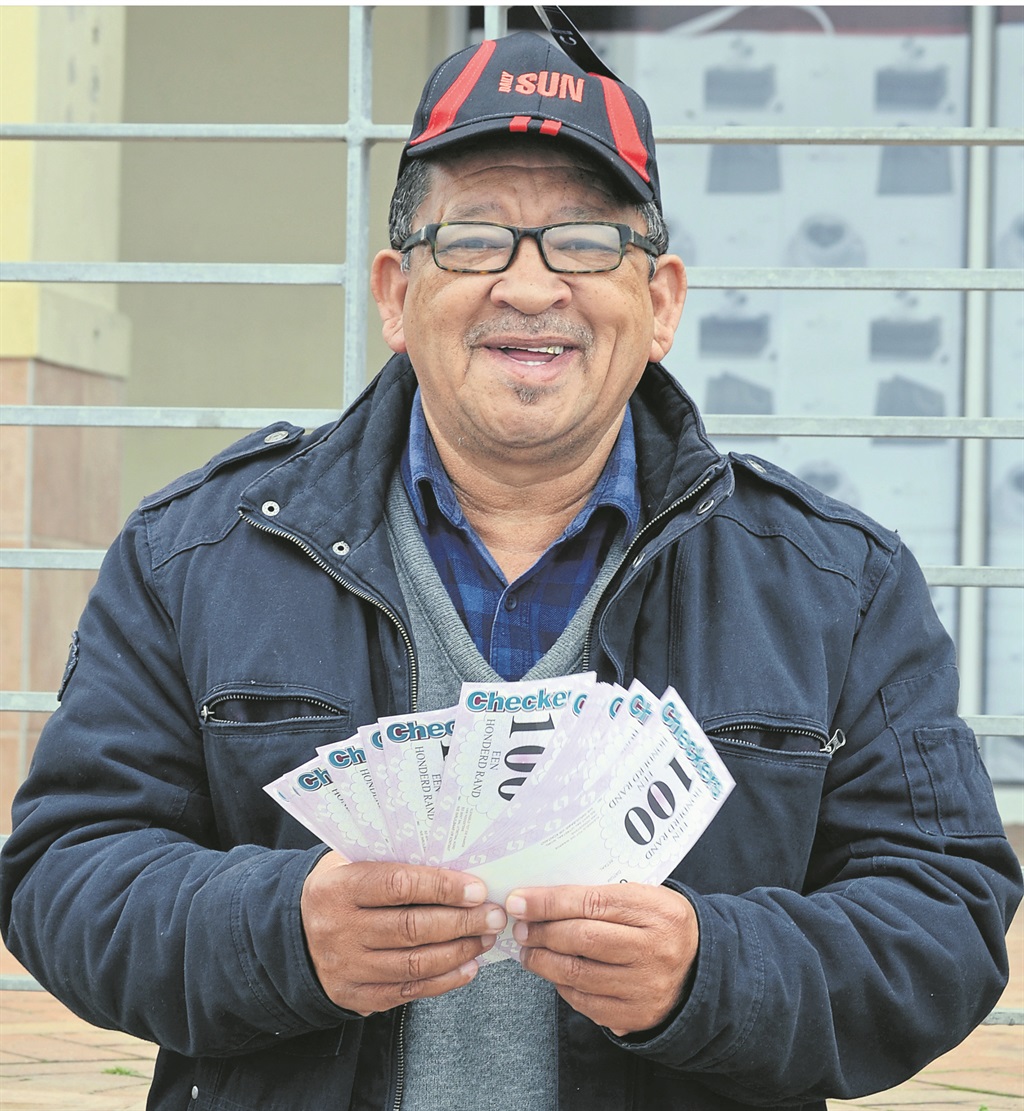 George holds his grocery vouchers.     Photo by      Luvuyo   Mehlwana 