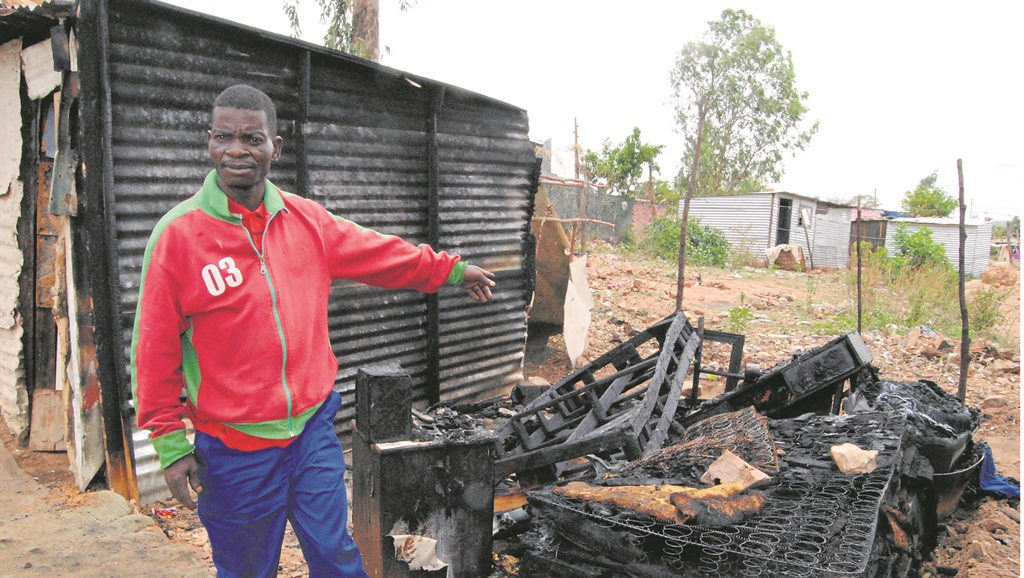 Lucas Mathebula points to the bed where the couple died on Friday night. Photo by Happy Mnguni 