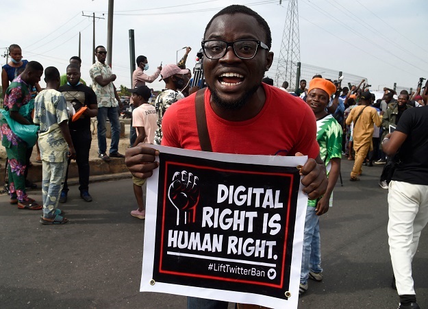 A man carries a banner during a demonstration at Ojota in Lagos over a Twitter blackout. 