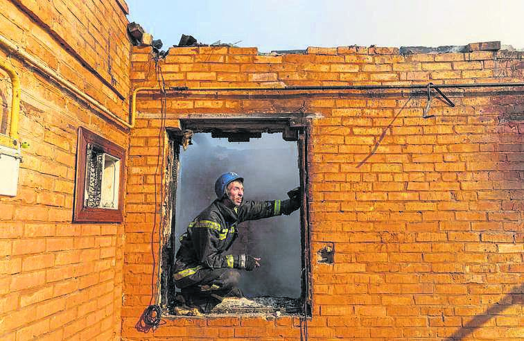 A firefighter works at a residential district that was damaged by shelling, as Russia’s invasion of Ukraine continues, in Kyiv, Ukraine. (PHOTO: REUTERS/Marko Djurica)