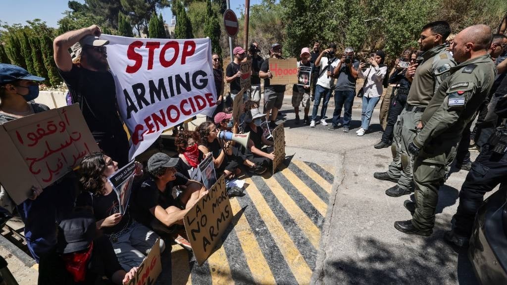 Members of the Israeli security forces stand guard during an anti-war sit in organised by Israeli left-wing activists, in front of the British Consulate General in Jerusalem, amid the ongoing conflict between Israel and the Palestinian Hamas movement in the Gaza Strip. (Ahmad Gharabli/AFP)