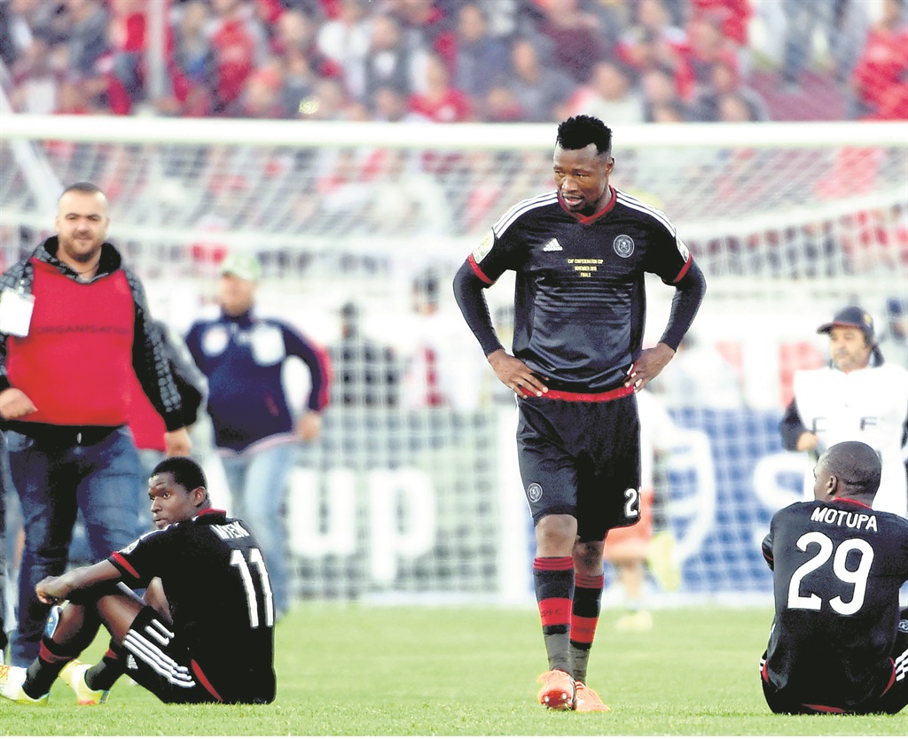 A BAD DAY AT THE OFFICE: Orlando Pirates players look dejected as Etoile du Sahel celebrate their Confederation Cup victory (INSET).  Photos by Gallo Images 