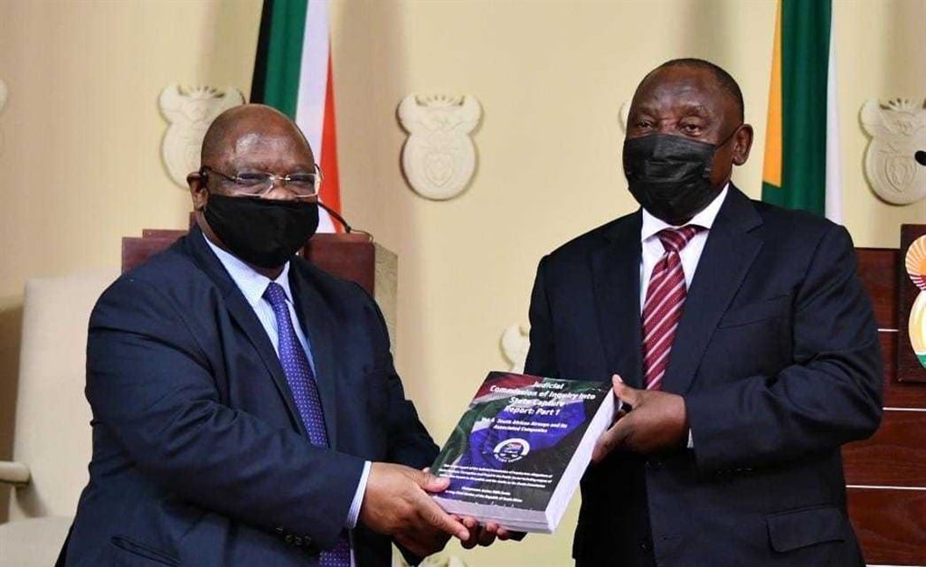 Deputy Chief Justice Raymond Zondo hands part 1 of the state capture report to President Cyril Ramaphosa.