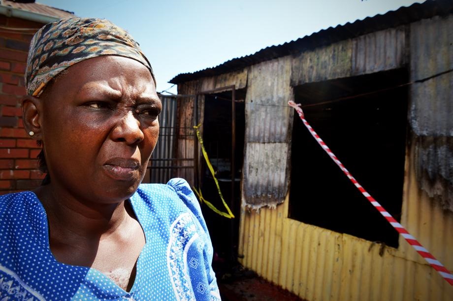SORROW: Gugu Mhlanga’s aunt, Onica Sikhakhane (50), stands ouside the burnt-out shack. 
Photo by 
Lucky Morajane