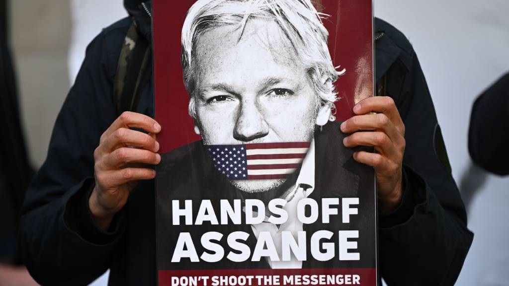 Supporters and activists hold placards calling for WikiLeaks founder Julian Assange to be freed. 