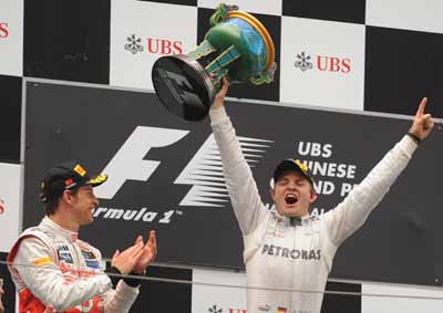<b>MOMENT IN HISTORY:</b>Young Mercedes driver Nico Rosberg is utterly elated by taking a maiden pole and his first win from the 2012 Chinese F1 GP. Also happy for him is McLaren's Jenson Button. <i>Image: AFP</i>