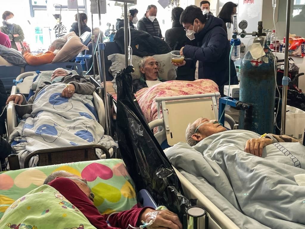 Patients on stretchers are seen at Tongren hospita