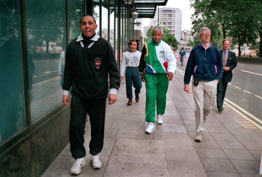 South African President Nelson Mandela takes a 6 am walking along Park Lane, accompanied by his bodyguards, during a visit to London, July 1996. He is wearing a track suit in the South African national colours, with the Olympic logo on them. (Photo by Tom Stoddart/Getty Images)