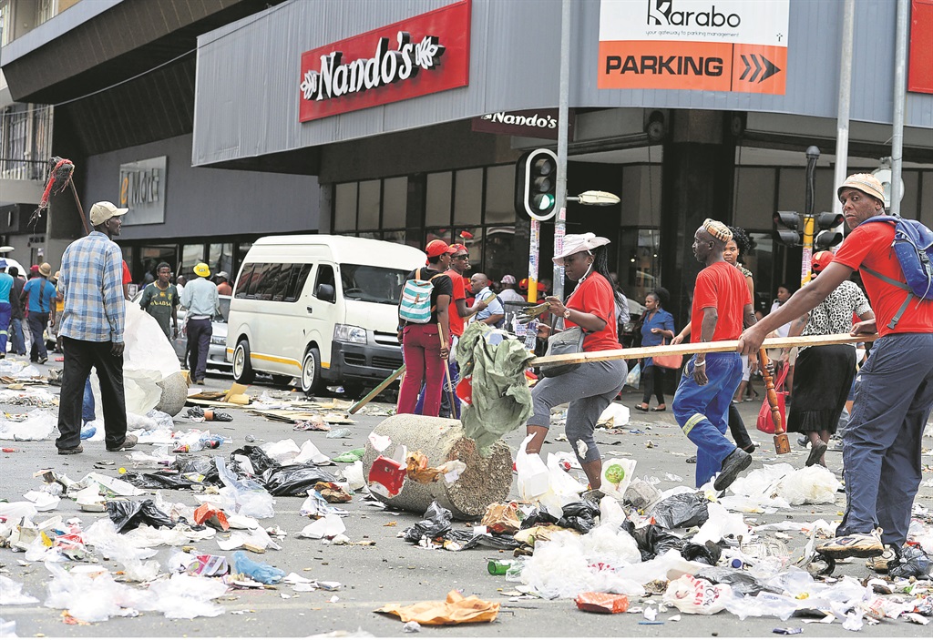 Pikitup workers emptied all the rubbish bins in the Joburg CBD.                                                        Photo by Trevor Kunene  