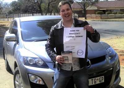 <b>ELATED PETROL HEAD:</b> Wheels24's latest reader's test winner shows off his prize. 