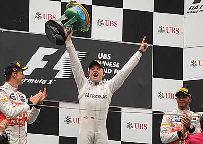 <b>ROSBERG CHAMP IN CHINA:</b> Mercedes' Nico Rosberg celebrates winning the 2012 Chinese F1 GP with (left) McLaren's Jenson Button and (right) Lewis Hamilton who were second and third respectively. <i>Image: AFP</i>