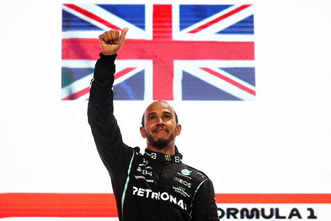 Race winner Lewis Hamilton of Great Britain and Mercedes GP celebrates on the podium during the F1 Grand Prix of Qatar at Losail International Circuit on November 21, 2021 in Doha, Qatar. 